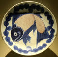 Porcellaneous stoneware Min yao plate painted with blue fish from China at Montreal Museum of Fine Arts. Montreal, QC.