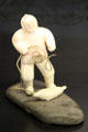 Inuit carved ivory & steatite hunter pulling seal from ice breathing hole at Montreal Museum of Fine Arts. Montreal, QC.