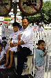 Father sits with his children in Urumqi. China.