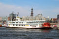 Mississippi Queen paddle wheel tour boat on Elbe River with St Michael's Church in background. Hamburg, Germany.