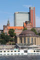 Red tower of Atlantic-Haus above Brown dome of Alter Elbtunnel at St Pauli Pier. Hamburg, Germany.