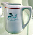 Porcelain milk pitcher with image of whale & flag from whaling shipping company at International Maritime Museum. Hamburg, Germany.