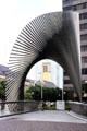 Modern fan-shaped parametric archway sculpture by Andreu Alfaro Hernández over pedestrian bridge to City Haus, a 42 story skyscraper at Friedrick Ebert Anlage square. Frankfurt am Main, Germany.