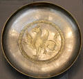 Partially gilded silver plate with griffin from Iran at Pergamon Museum. Berlin, Germany.