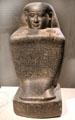 Egyptian stone block statue of chief steward Harua with Hieroglyphics from Thebes at Neues Museum. Berlin, Germany.