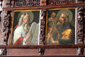 Paintings of Moses with horns holds tables & King David play harp on organ loft at St Jacob's Church. Lübeck, Germany.