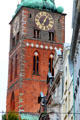 Brick clock tower of St Jacob's Church with quoins & Gothic arches. Lübeck, Germany.