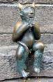 Devil's figure sculpted in bronze sitting on Devil's Stone by Rolf Goerler Bildhauer at St Mary's Church. Lübeck, Germany.