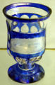 Stemmed two-colored goblet where blue glass is cut away & etched to form picture of Helgoland at Schleswig Holstein State Museum. Schleswig, Germany.