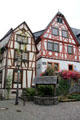 Multi-story half-timbered buildings & old covered well. Bacharach, Germany.