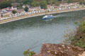 Sightseeing boat traveling along Rhine River as seen from viewpoint atop The Loreley with camper village beyond. Loreley, Germany.