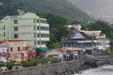 Colorful buildings nestled against hills. Roseau, Dominica.