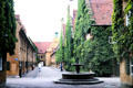 Streetscape with fountain at Fuggerei. Augsburg, Germany.