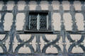 Half-timbered building with window made of multiple blown-glass rounds. Bamberg, Germany.