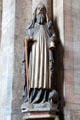 Carving of St Anthony the Great with pig, bell, & monk's habit symbols at St Sebaldus Church. Nuremberg, Germany