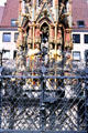 Details of figures & wrought iron fencing of Schöner Brunnen on City Hall Market square. Nuremberg, Germany.