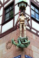 Sculpture of St. Michael slaying dragon on corner of building on Tiergärtnertorplatz. Nuremberg, Germany
