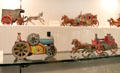 Wind-up horse-drawn carriages, steam roller & fire wagon at City Toy Museum. Nuremberg, Germany.