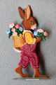 Flat tin rabbit figure with basket of flowers on cast stand from Germany in private collection. Germany.