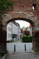 Brick arch in Memmingen city wall with town. Memmingen, Germany.