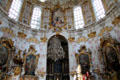 Rococo interior with ornate chandelier hanging from dome of Ettal Benedictine Abbey. Ettal village, Germany.