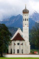 St Coloman baroque church in Schwangau in pastoral setting with Alps in background. Füssen, Germany