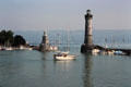 Entrance to Lindau port commanded by lighthouse & monument to Lion of Bavaria. Lindau im Bodensee, Germany.