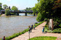 Pedestrians enjoying walkway along Danube River. Ulm, Germany.
