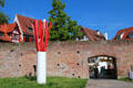 Ulm brick city wall with modern sculpture beside gate leading from Danube to Fischergasse. Ulm, Germany.