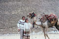 Tourists with camel at Great Pyramid. Giza, Egypt.