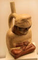 Moche ceramic stirrup-spout bottle of a sick man from Peru at Museum of America. Madrid, Spain.