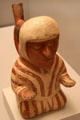 Moche ceramic stirrup-spout bottle man in stripped robe from Peru at Museum of America. Madrid, Spain.