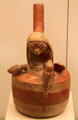 Moche ceramic stirrup-spout bottle in shape of bird surrounded by young from Peru at Museum of America. Madrid, Spain.