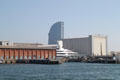 Yacht shipyard with curved W Hotel beyond. Barcelona, Spain.