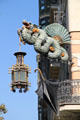 Dragon sculpture holding Chinese lantern & fan over umbrella at Casa Bruno Cuadros on La Rambla. Barcelona, Spain