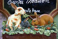 Rabbits on painted shop sign. Riquewihr, France.