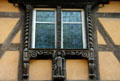 Carved window frame on half-timbered house. Riquewihr, France.