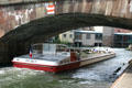 Tourist boat under bridge of L'Ill River. Strasbourg, France.