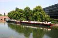 Barges on L'Ill River beside Vauban Dam & Hotel du Departement. Strasbourg, France.