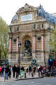 St-Michel Fountain affixed to end wall of building as part of vista plan by Baron Haussmann. Paris, France