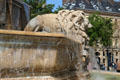 Lion statue on octagonal basin of St-Sulpice fountain. Paris, France.