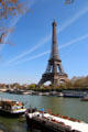 Eiffel Tower over Seine house boats. Paris, France.