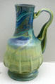 Multicolor French pitcher with abstract handle at Museum of Decorative Arts. Paris, France.