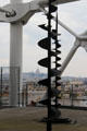 Spiral sculpture on upper deck at Georges Pompidou Center with Sacre Coeur church & Montmartre in distance. Paris, France.