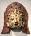 Gilded copper statue with gems of Siva mask from Nepal at Guimet Museum. Paris, France.