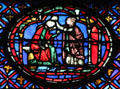 Seated man with woman stained glass scene at St Chapelle. Paris, France
