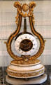 Lyre shaped clock with gilded bronze, white marble, enamel & glass by Charles Bertrand at Carnavalet Museum. Paris, France