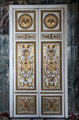 Elaborately carved doors in salon of abundance at Versailles Palace. Versailles, France.