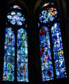 Stained glass images of Virgin & Crucifixion above Old Testament stories by Marc Chagall in Reims Cathedral. Reims, France.