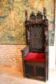 Ornately carved throne chair with crest of France in Great Hall at Château de Clos Lucé. Amboise, France.